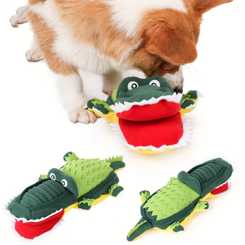 Corgi playing with green crocodile plush dog toy. Durable, interactive pet toy for chewing and fetching. Perfect for small to medium dogs.