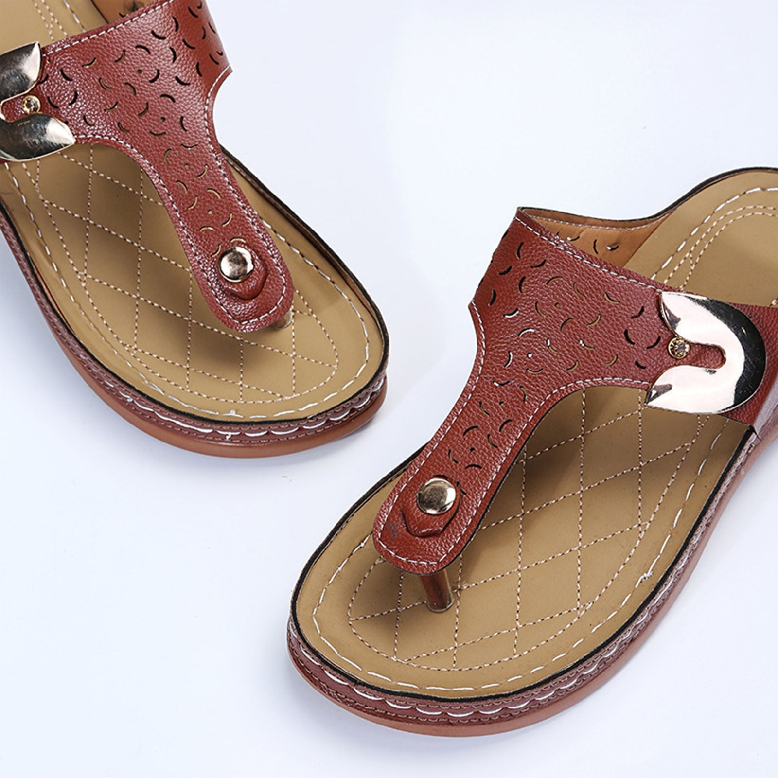 Brown leather women's sandals with cushioned sole, featuring intricate cut-out design and metallic accents, perfect for summer fashion and comfort.