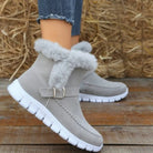 Gray suede winter boots with faux fur lining and white rubber soles, worn with denim jeans. Stylish women's footwear for cold weather.