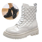 White patent leather combat boots with quilted design, thick lug sole, and lace-up front. Stylish women's footwear for fashion-forward looks.