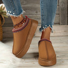 Brown slip-on shoes with red and white embroidered trim, worn with frayed denim jeans. Stylish casual footwear for women, perfect for fall fashion.