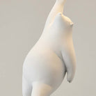 Minimalist white polar bear sculpture reaching upward, modern art decor, smooth finish, contemporary design, perfect for home or office display.