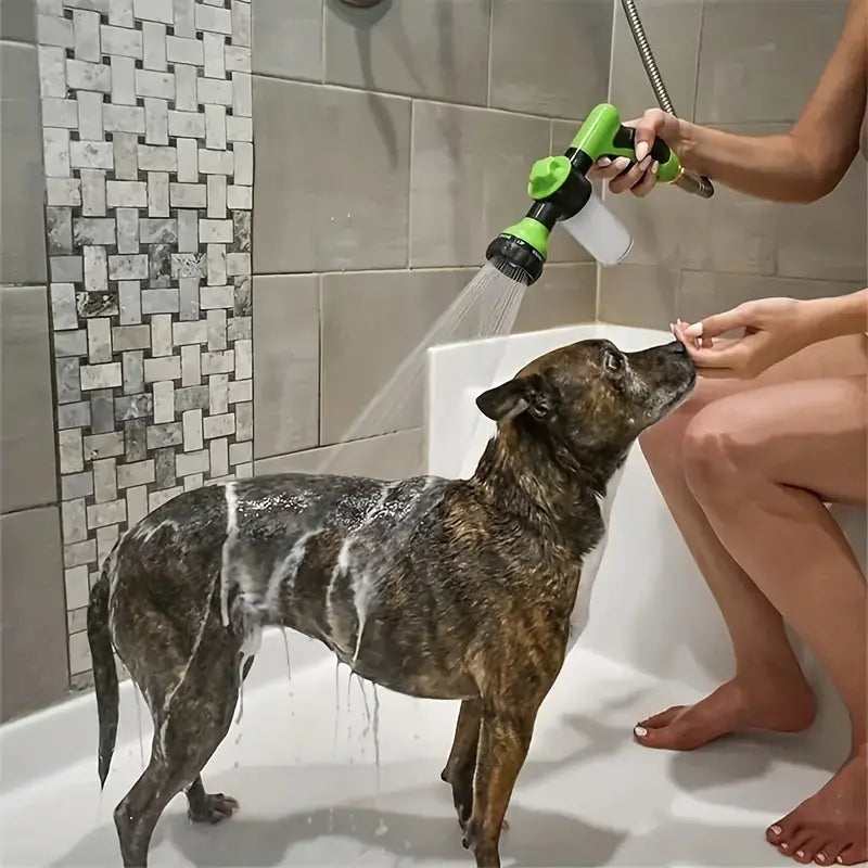 Dog being bathed in a shower with a green handheld sprayer, surrounded by tiled walls. Pet grooming, dog washing, home bath time.