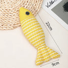 Yellow fish-shaped cat toy with white zigzag pattern, measuring 22cm by 9cm, on a woven mat. Ideal for pet play, durable and stylish design.