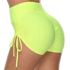 Bright yellow high-waisted ruched sports shorts with side drawstrings, textured fabric, perfect for gym workouts and activewear fashion.