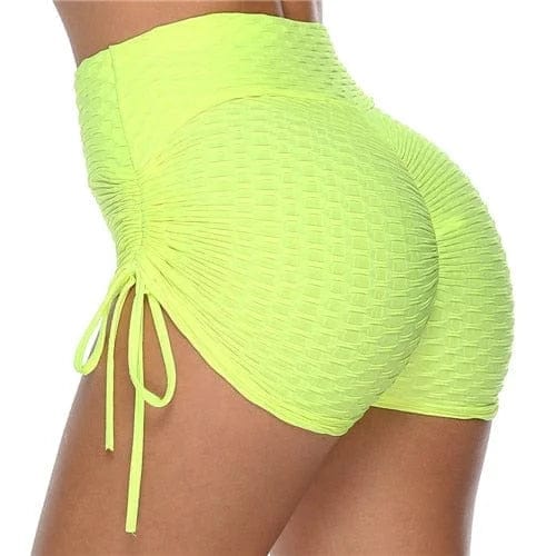 Bright yellow high-waisted ruched sports shorts with side drawstrings, textured fabric, perfect for gym workouts and activewear fashion.