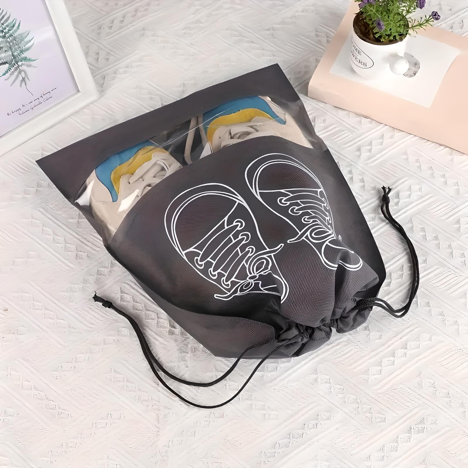 Drawstring shoe bag with sneaker design, transparent front, and black fabric, ideal for travel and storage. Stylish, practical shoe organizer.