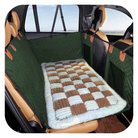 Green pet car seat cover with quilted design, protecting vehicle interior. Durable, waterproof, easy to clean, ideal for dog owners.