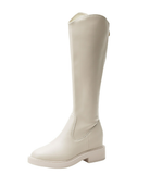 Cream knee-high leather boot with block heel, sleek design, and minimalist style. Perfect for fashion-forward outfits and versatile wear.