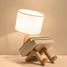 Modern wooden book lamp with a unique design, featuring a warm white lampshade and two books as a base, perfect for home decor and reading spaces.