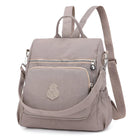 Stylish taupe backpack purse with multiple compartments, adjustable straps, and front zipper pocket. Perfect for travel, school, or everyday use.