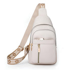 White leather crossbody sling bag with gold zippers and adjustable patterned strap, ideal for travel and daily use. Stylish and functional accessory.