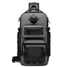 Sleek gray tactical backpack with multiple compartments, durable zippers, and adjustable straps. Ideal for travel, hiking, and outdoor activities.