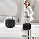 Woman in white suit with black and white luggage set, featuring a sleek carry-on and matching suitcase. Stylish travel fashion, modern luggage design.