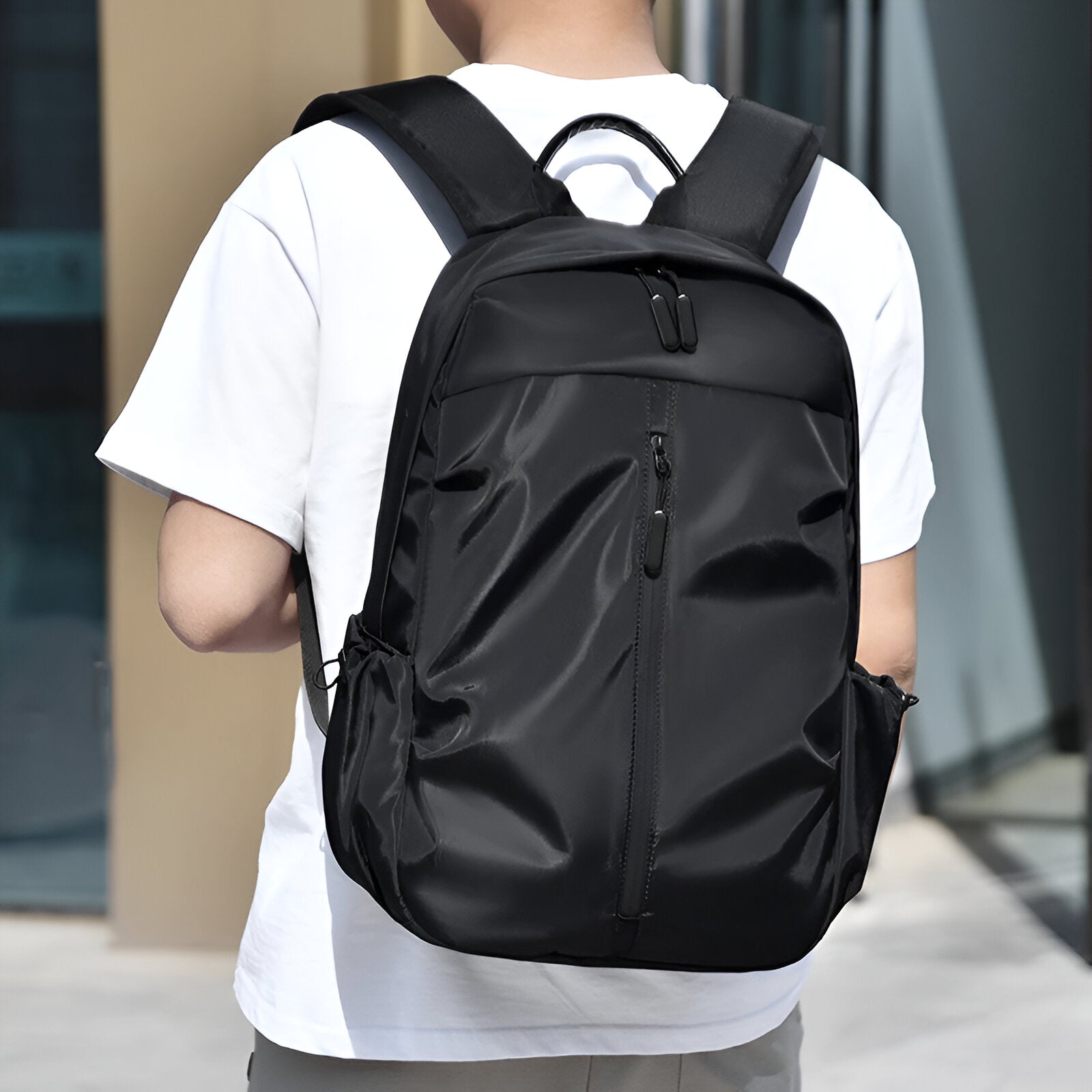 Sleek black waterproof backpack with multiple compartments, ergonomic design, and adjustable straps, ideal for travel, school, or work.