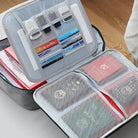 Open suitcase organizer with mesh pockets holding passports, travel documents, and credit cards on a wooden floor. Travel essentials storage solution.