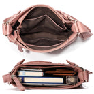 Open pink leather handbag with multiple compartments, showcasing organized storage for books, wallet, and essentials. Perfect for stylish, practical use.