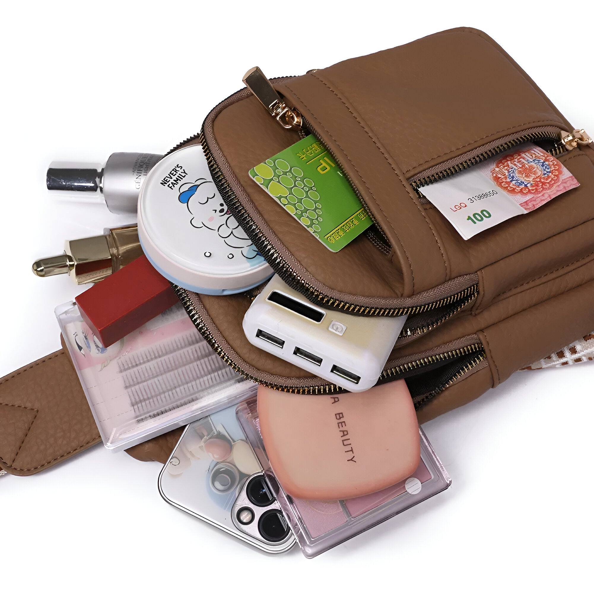 Brown leather crossbody bag with multiple compartments, showcasing contents like cosmetics, smartphone, power bank, and currency. Fashion accessory keywords.