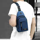 Man wearing a stylish blue crossbody sling bag with multiple compartments, ideal for travel and casual use. Fashionable men's accessory.