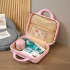 Pink travel toiletry bag with skincare products, cosmetics, and accessories, open on a wooden floor. Ideal for organized packing and travel essentials.