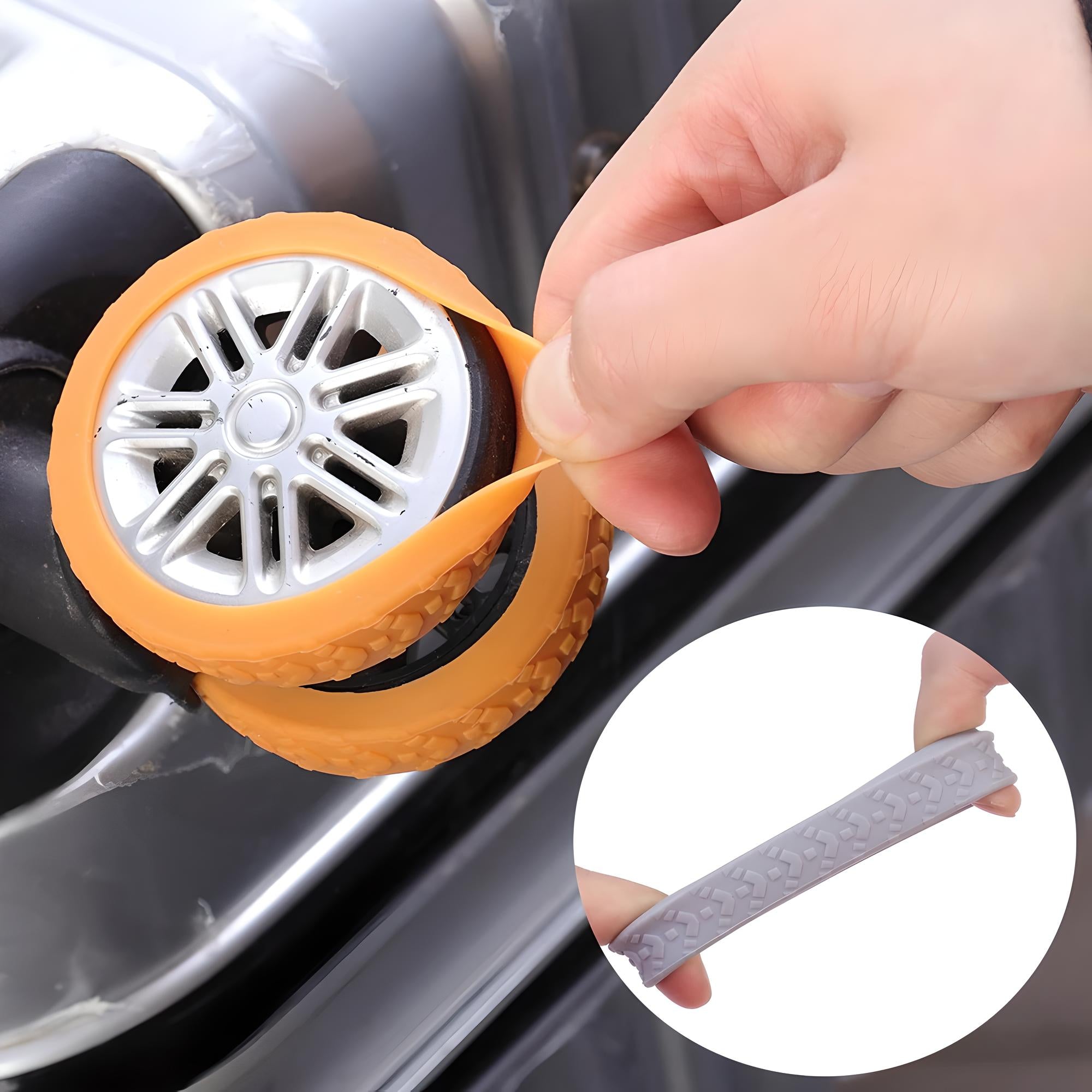 Hand applying orange silicone tire cover on a silver suitcase wheel, with an inset showing a gray tire cover. Durable luggage wheel protector.