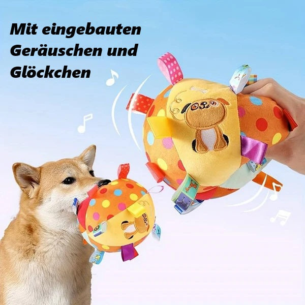 Dog playing with colorful interactive plush toy ball featuring built-in sounds and bells, ideal for pet entertainment and sensory stimulation.