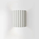 Minimalist white Nordic LED wall lamp with ribbed design, ideal for modern living rooms, bedrooms, and study decor. Energy-efficient lighting fixture.