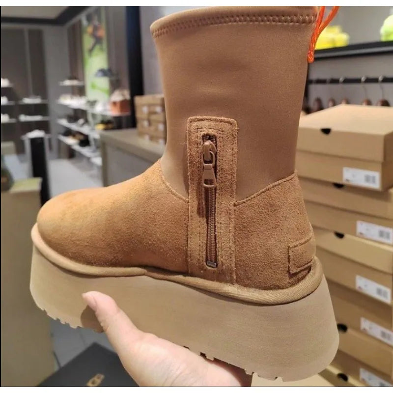 Tan suede snow boot with plush lining, waterproof design, anti-slip sole, and side zipper. Ideal for winter outdoor activities. Women's fashion footwear.