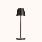 Sleek black modern table lamp with a minimalist design, featuring a cylindrical base and shade, perfect for contemporary home decor lighting.