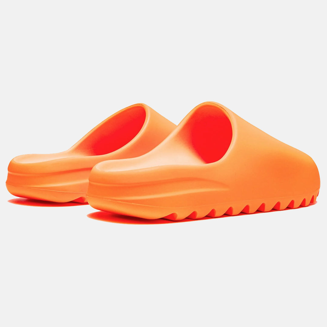 Bright orange slip-on clogs with textured soles, perfect for casual wear. Lightweight, durable footwear ideal for summer fashion and comfort.