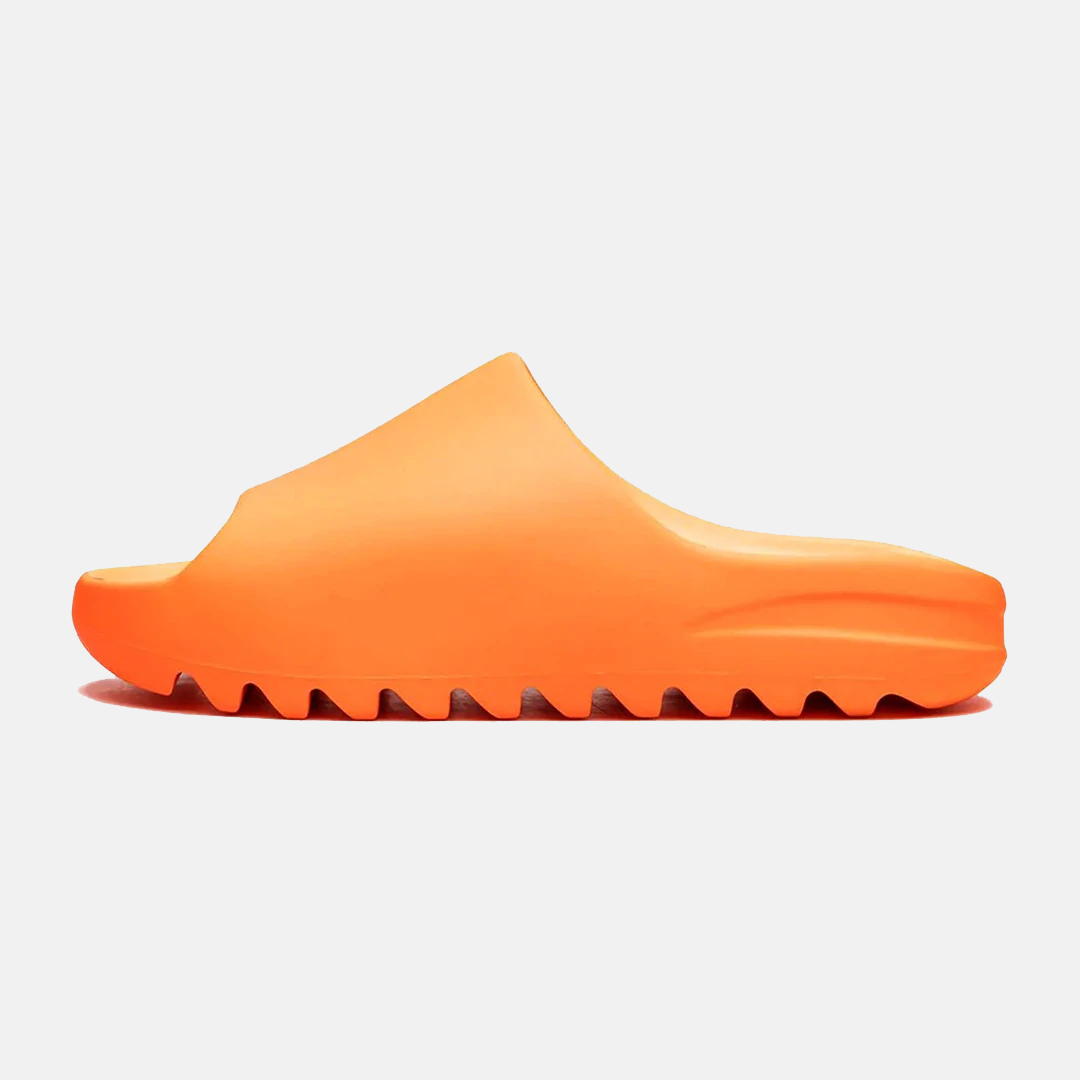 Bright orange slide sandal with a minimalist design and textured sole, perfect for casual wear. Comfortable, stylish footwear for summer fashion.