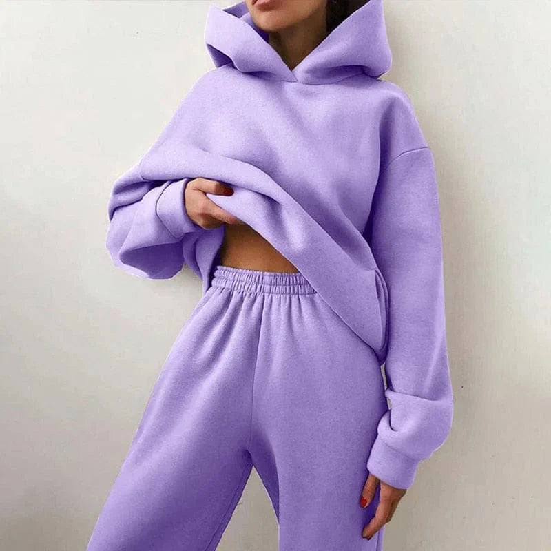 Woman wearing a stylish purple hoodie and sweatpants set, showcasing casual fashion. Cozy loungewear, perfect for comfort and style.
