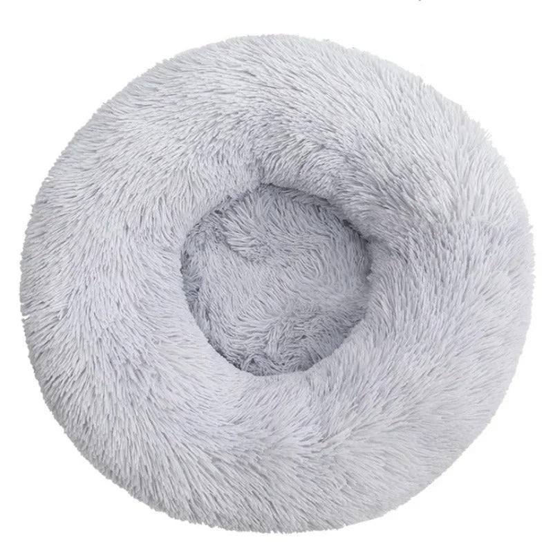 Round fluffy gray pet bed, donut shape, plush faux fur, cozy and soft for cats and small dogs, ideal for comfort and warmth, non-slip bottom.