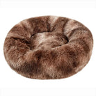 Round plush pet bed in soft brown faux fur, ideal for cats and small dogs. Cozy, comfortable, and stylish pet accessory for restful sleep.