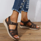 Women's brown leather sandals with adjustable straps, cushioned sole, and casual design. Perfect for summer fashion and comfort.