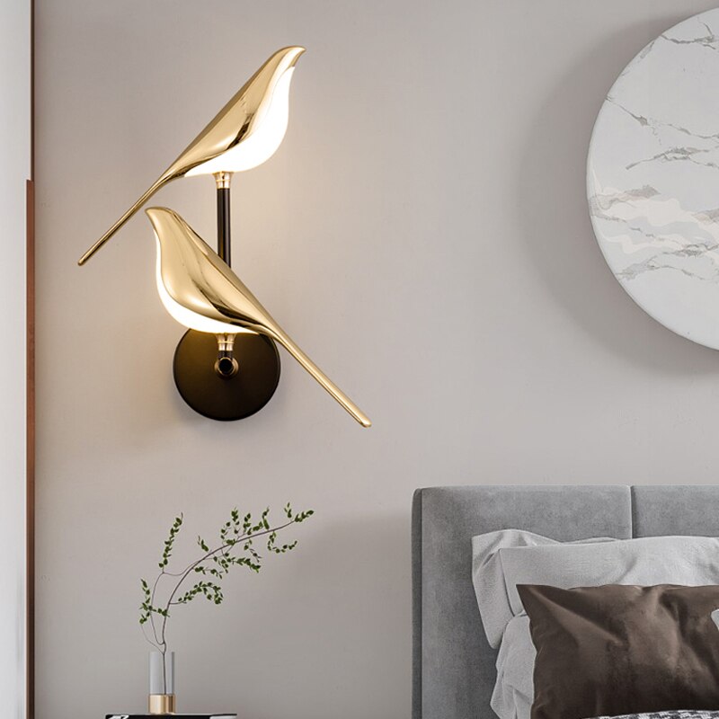 Gold-plated bird design LED wall lamp on a modern bedroom wall, featuring creative lighting fixtures for living room and bedroom decor.