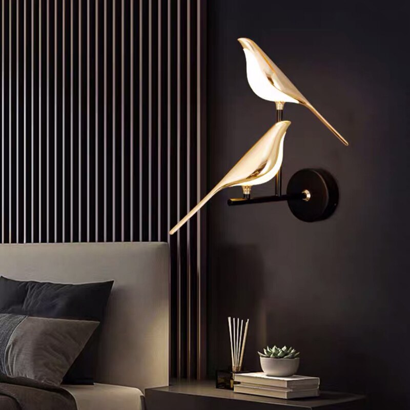 Gold bird design LED wall lamp in modern living room; creative lighting fixture for bedroom decor, featuring sleek gold plating and elegant aesthetics.