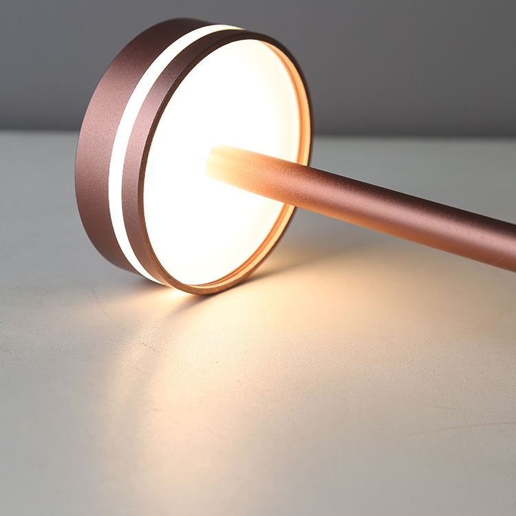 Modern copper LED desk lamp with circular design, soft ambient lighting, and sleek metallic finish, ideal for contemporary home or office decor.