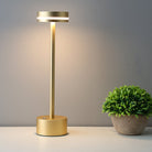 Modern gold LED table lamp with sleek design, illuminating a minimalist space. Energy-efficient lighting, perfect for contemporary home decor.