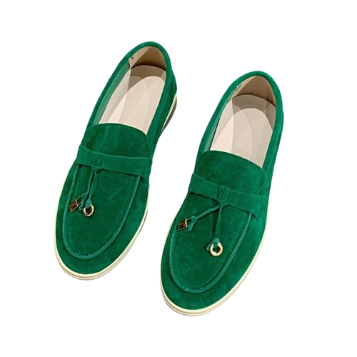 Green suede loafers with tassel detail, slip-on design, and white soles. Stylish men's footwear, perfect for casual and formal occasions.