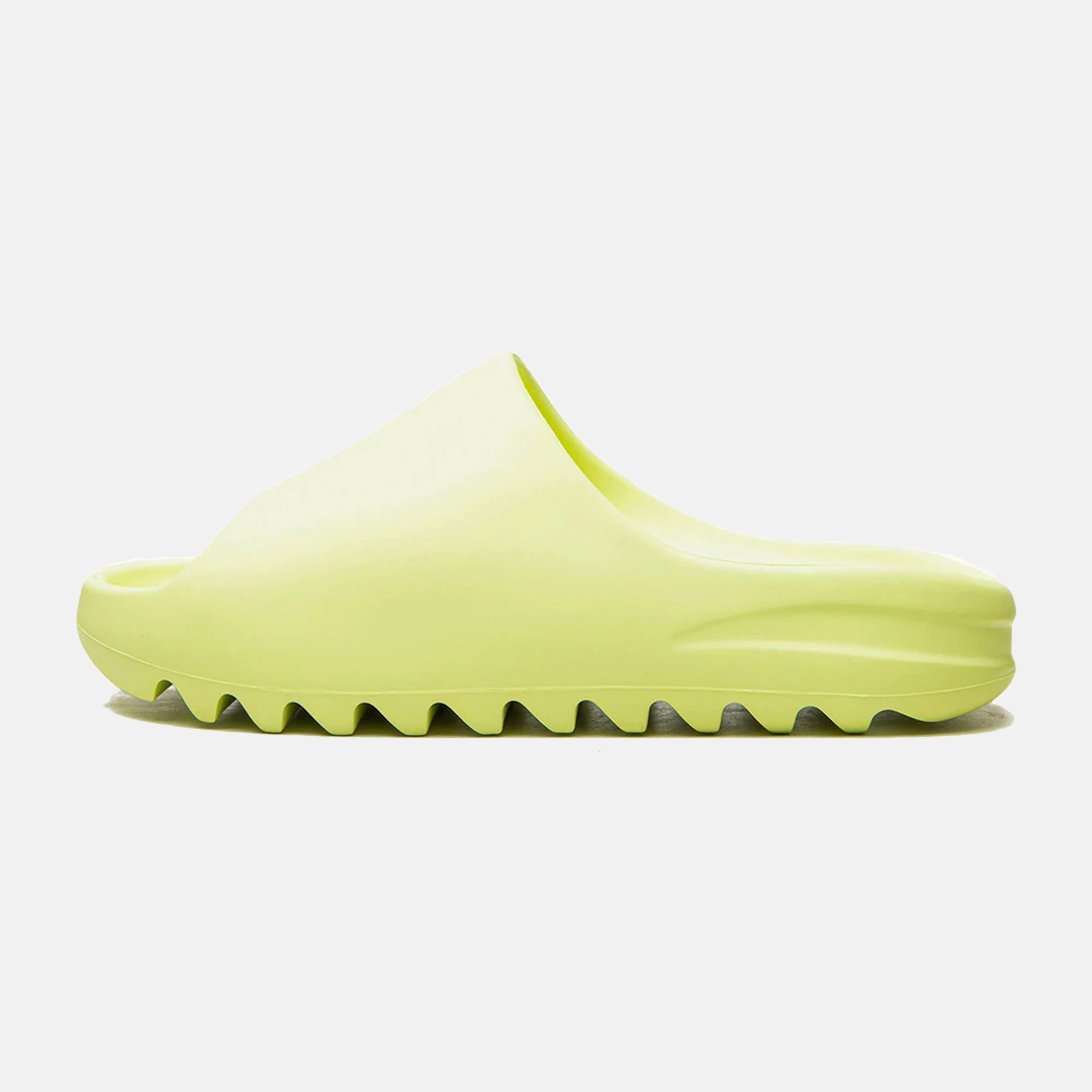 Neon green slide sandal with textured sole, minimalist design, and slip-on style. Perfect for casual wear, summer fashion, and comfortable footwear.