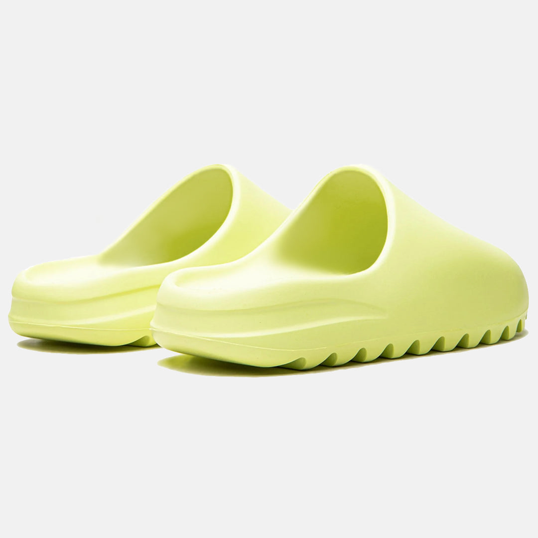 Neon green slip-on clogs with a minimalist design and ridged soles, perfect for casual wear. Lightweight, comfortable footwear for everyday use.