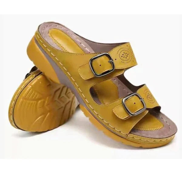 Yellow orthopedic women's sandals with dual buckle straps, cushioned sole, and floral cutout design. Comfortable footwear for casual wear.