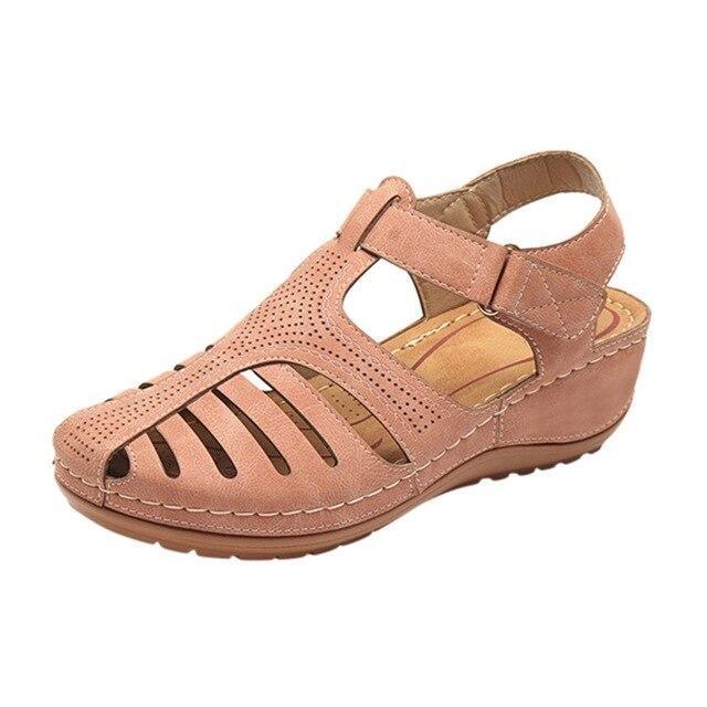 Women's orthopedic sandal with low wedge heel, breathable design, and correction function in pink. Ideal for comfort and support.