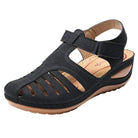 Black orthopedic sandal with low heel, breathable design, and correction function. Ideal for comfort and support. Perfect for casual wear.