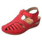 Red orthopedic sandal with low heel, breathable design, and correction function. Ideal for comfort and support. Perfect for summer footwear.