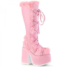 Pink fur-trimmed platform boots with lace-up design, high chunky heels, and camel accents. Trendy footwear for fashion-forward style enthusiasts.