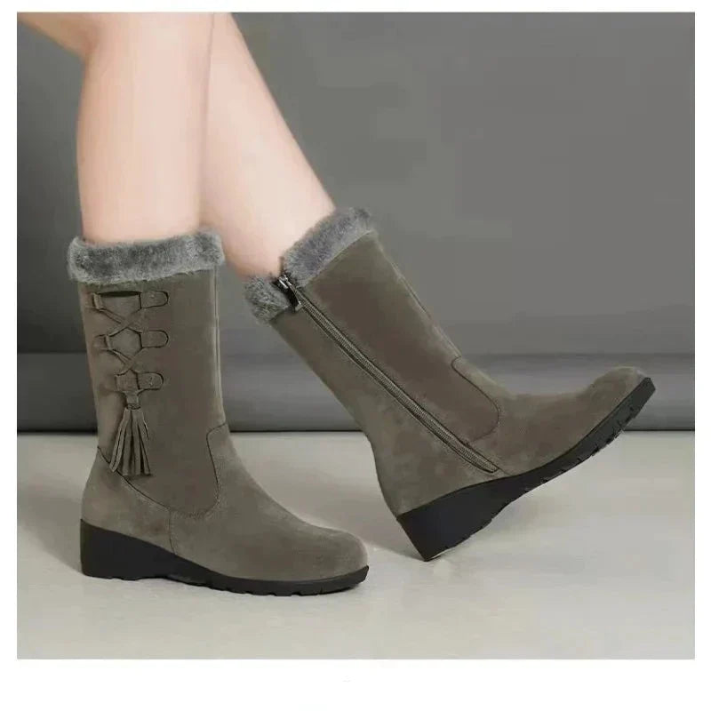 Women's mid-calf snow boots with faux fur trim, side zipper, and tassel detail; winter fashion, mid-heel, suede, plush lining.