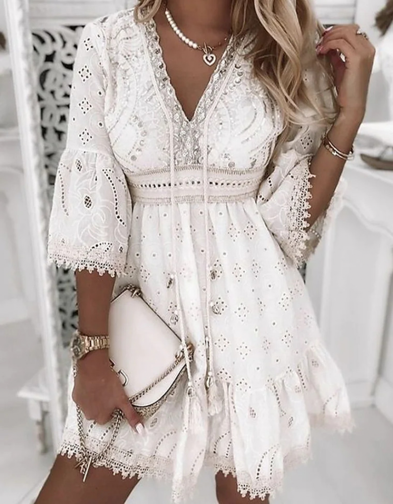 Elegant white lace dress with intricate embroidery, V-neckline, and bell sleeves. Perfect for summer fashion, weddings, or boho-chic style.