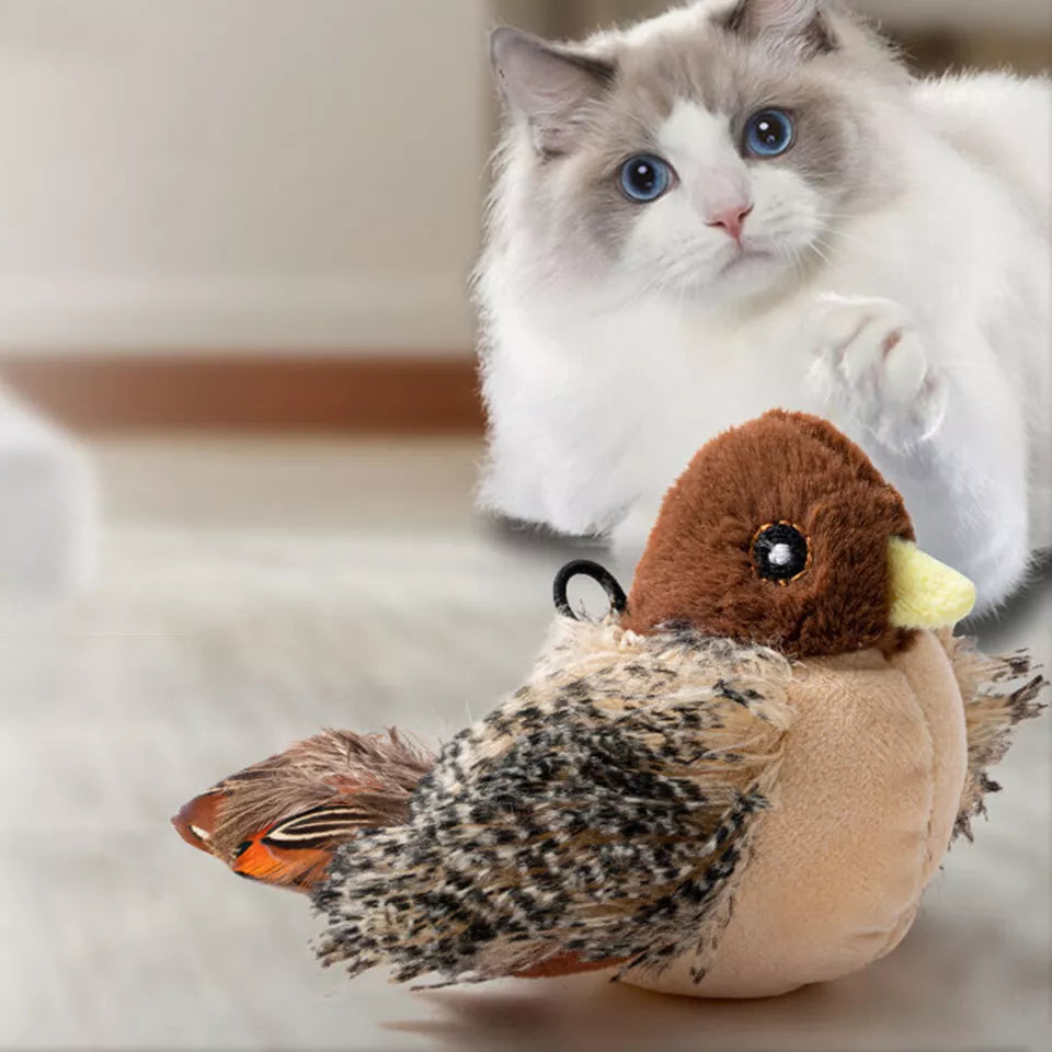 Fluffy cat playing with realistic plush bird toy on wooden floor; interactive pet toy for cats; lifelike design; perfect for indoor play.